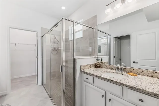 a bathroom with a granite countertop sink mirror and double