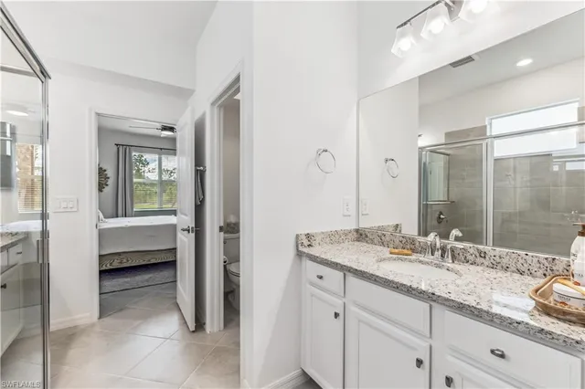 a spacious bathroom with a granite countertop sink mirror and double