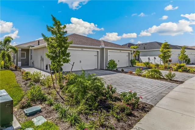 a white house with a yard and a garage