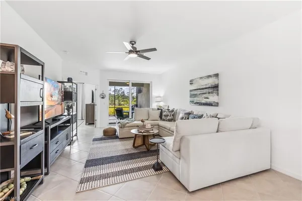 a living room with furniture a rug and a window