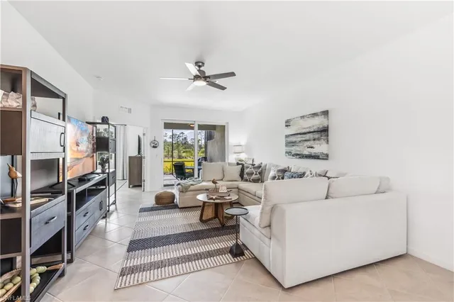 a living room with furniture a rug and a window