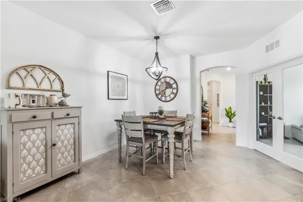 a view of a dining room and kitchen with furniture window and wooden floor