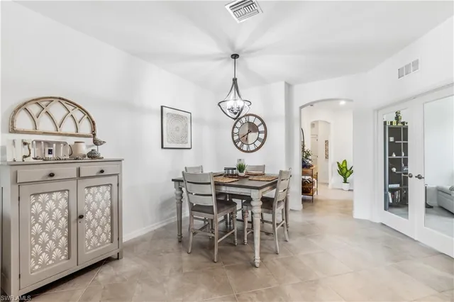 a view of a dining room and kitchen with furniture window and wooden floor