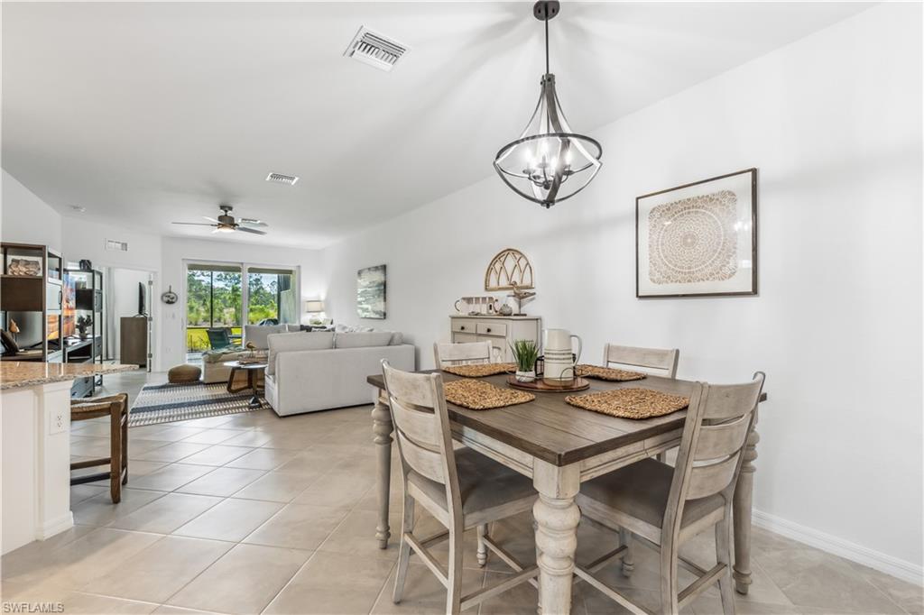 17716 Palmetto Pass Lane Babcock Ranch, FL 33982 - Photo 7 of 20 a view of a dining room with furniture window and wooden floor