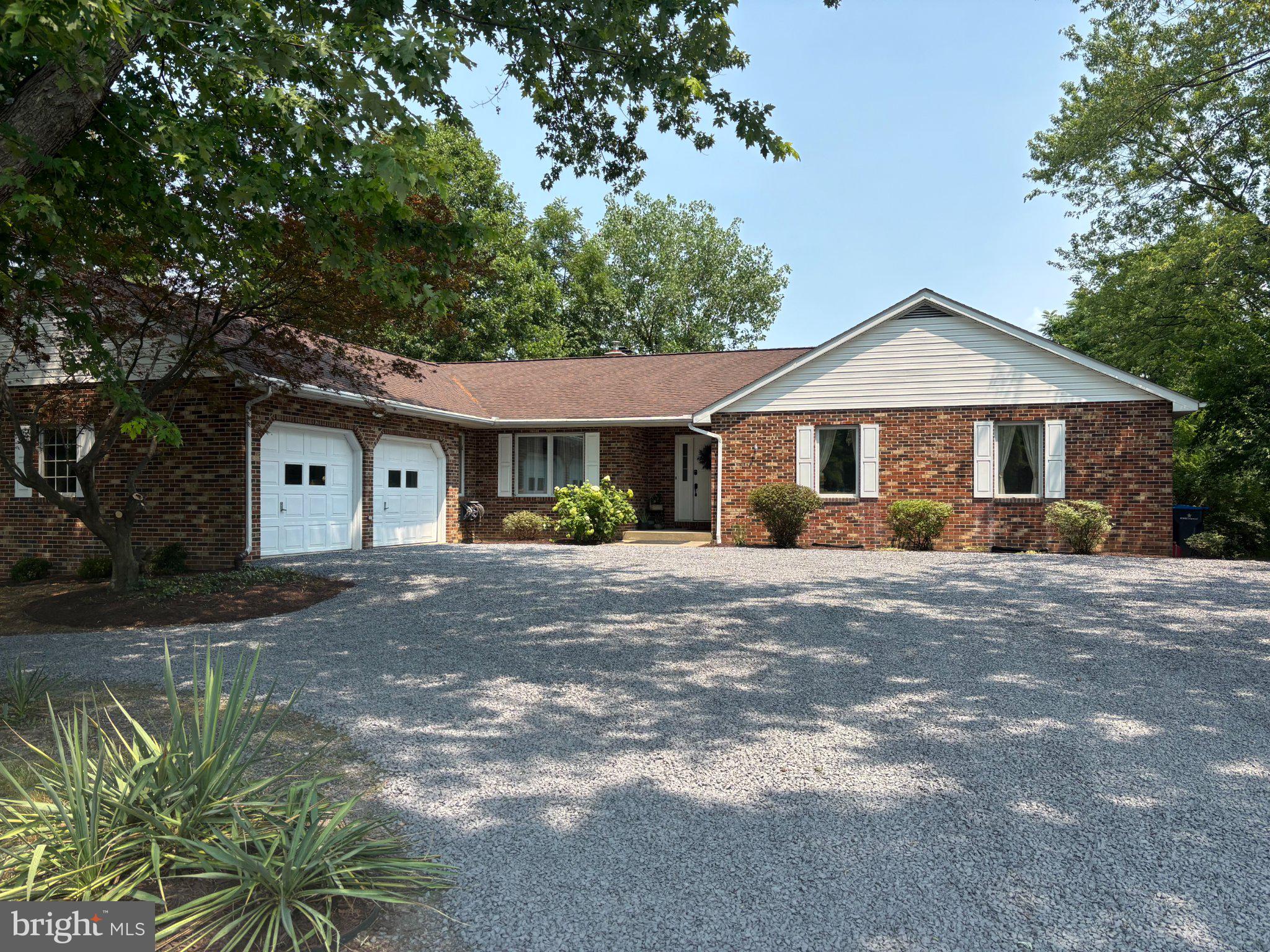 131 Spring Hollow Road Woodstock, VA 22664 - Photo 1 of 1 Charming brick home with lush greenery.