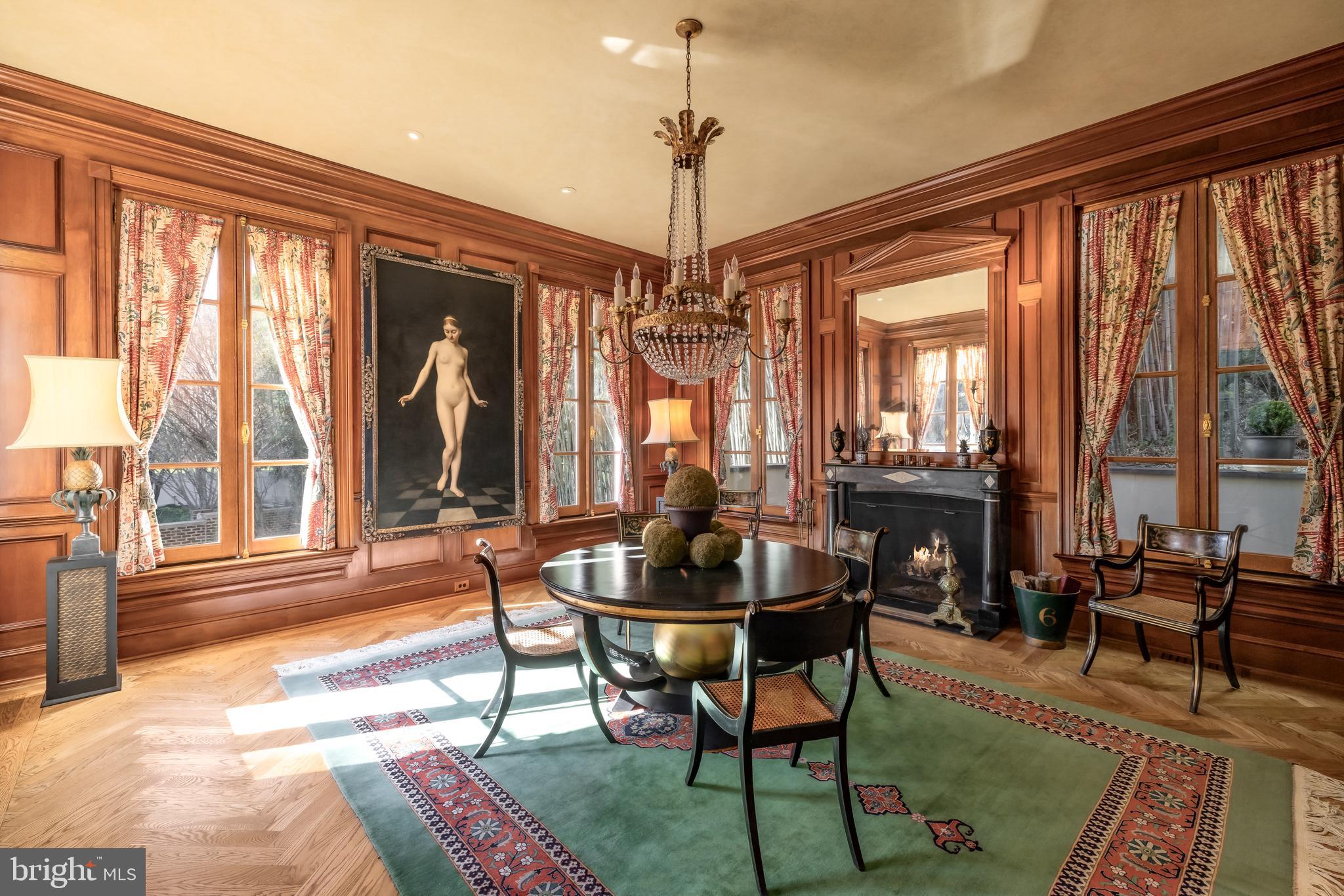 2740 Chain Bridge Road Northwest Washington, DC 20016 - Photo 6 of 50 a dining room with furniture large windows and a chandelier