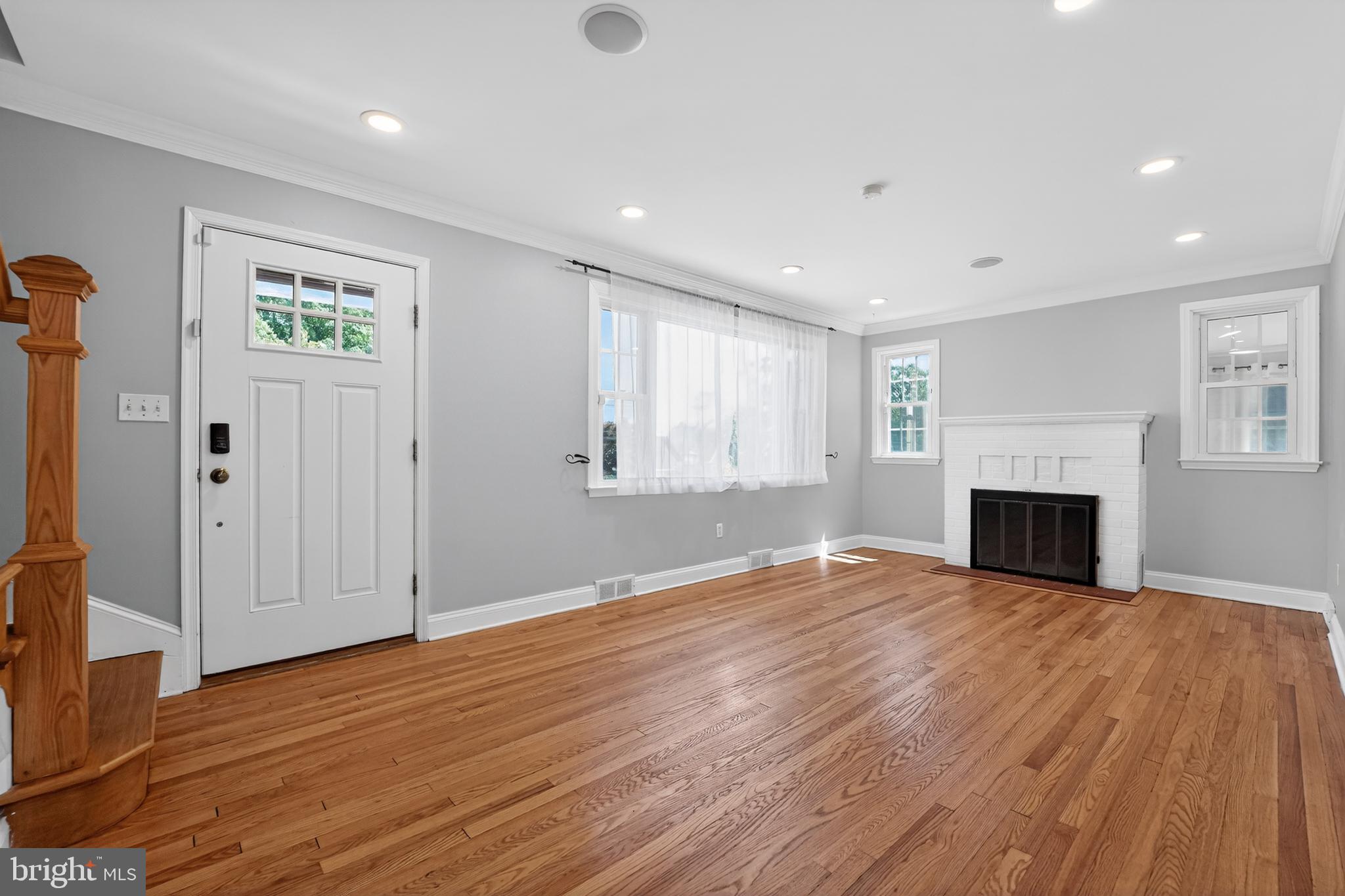 9408 Dana Vista Road Baltimore, MD 21236 - Photo 9 of 38 a view of empty room with wooden floor and fireplace