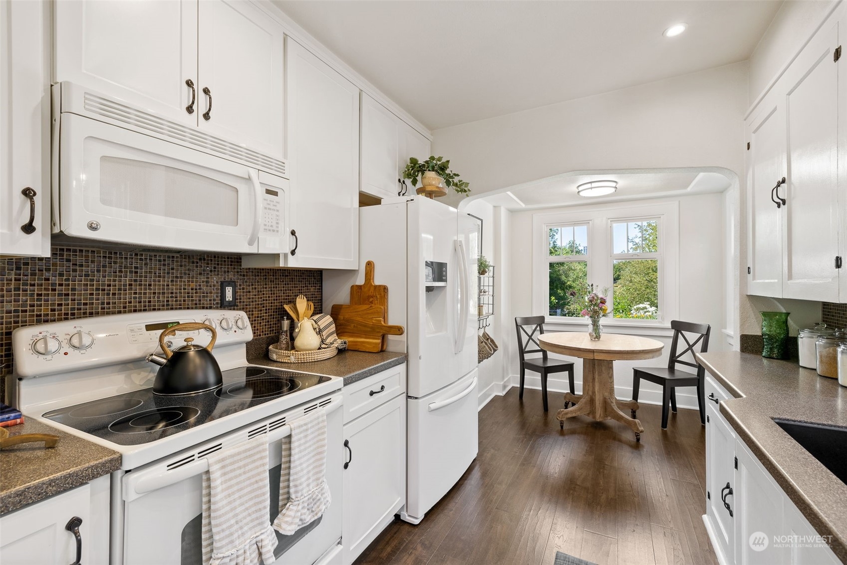 1232 Donovan Lane Everett, WA 98201 - Photo 8 of 34 a kitchen with a white cabinets and white appliances