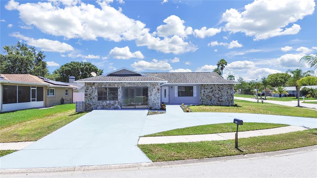 4652 Swallowtail Drive New Port Richey, FL 34653 - Photo 1 of 1 a front view of a house with garden