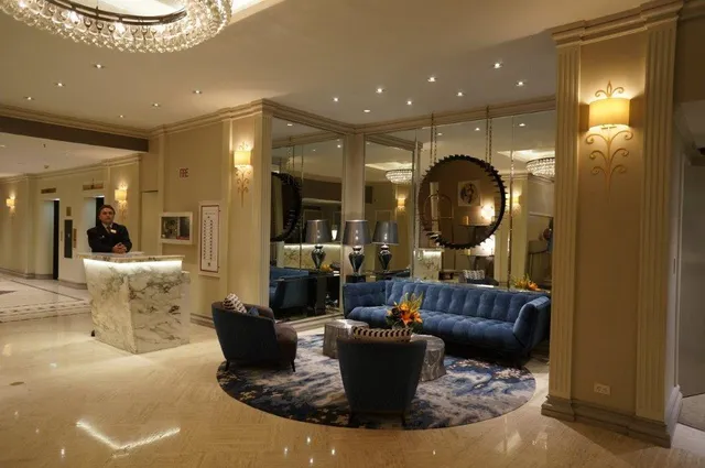 a bedroom with a bed and lamp on table