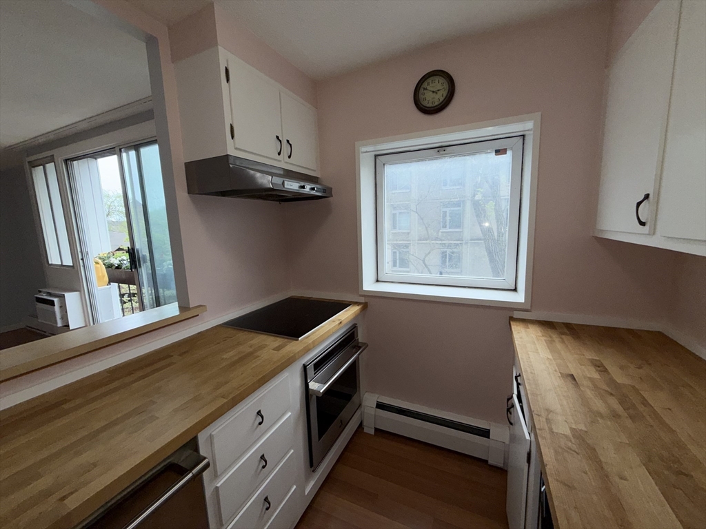 12 Inman Street, Unit 23 Cambridge, MA 02139 - Photo 5 of 14 a view of cabinets and window