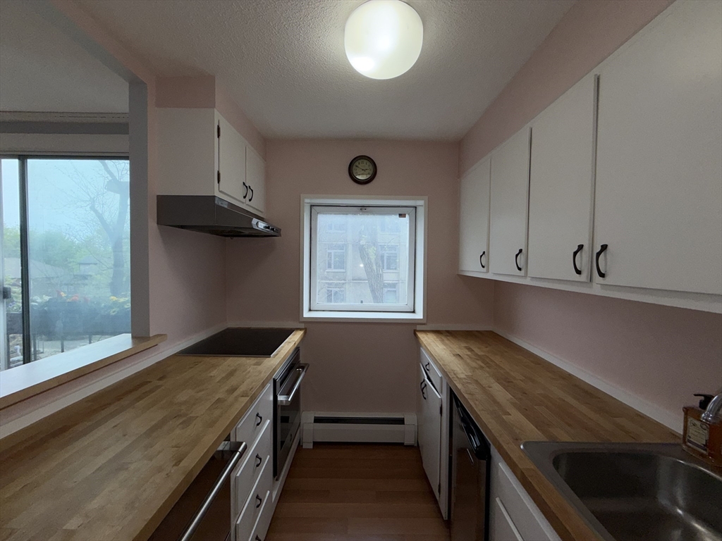12 Inman Street, Unit 23 Cambridge, MA 02139 - Photo 6 of 14 a kitchen with a stove and a window