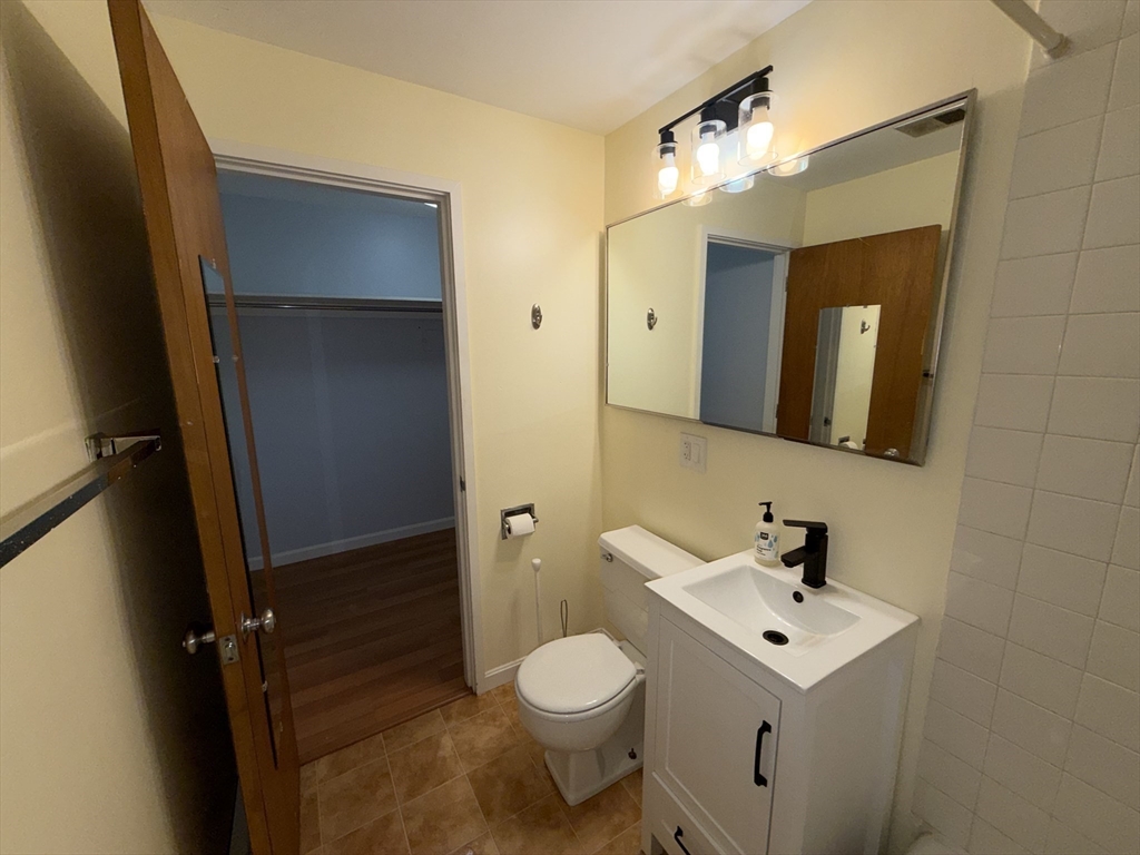 12 Inman Street, Unit 23 Cambridge, MA 02139 - Photo 10 of 14 a bathroom with a toilet sink and mirror