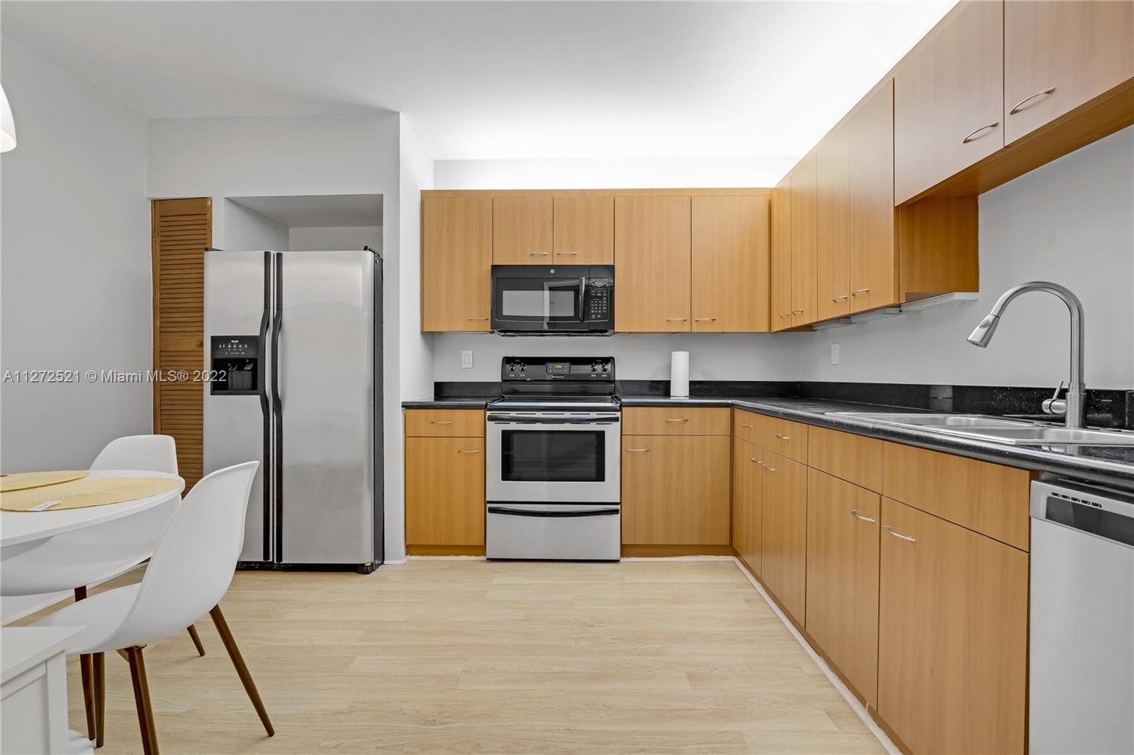 101 Crandon Boulevard, Unit 267 Key Biscayne, FL 33149 - Photo 11 of 57 a kitchen with a sink cabinets and stainless steel appliances
