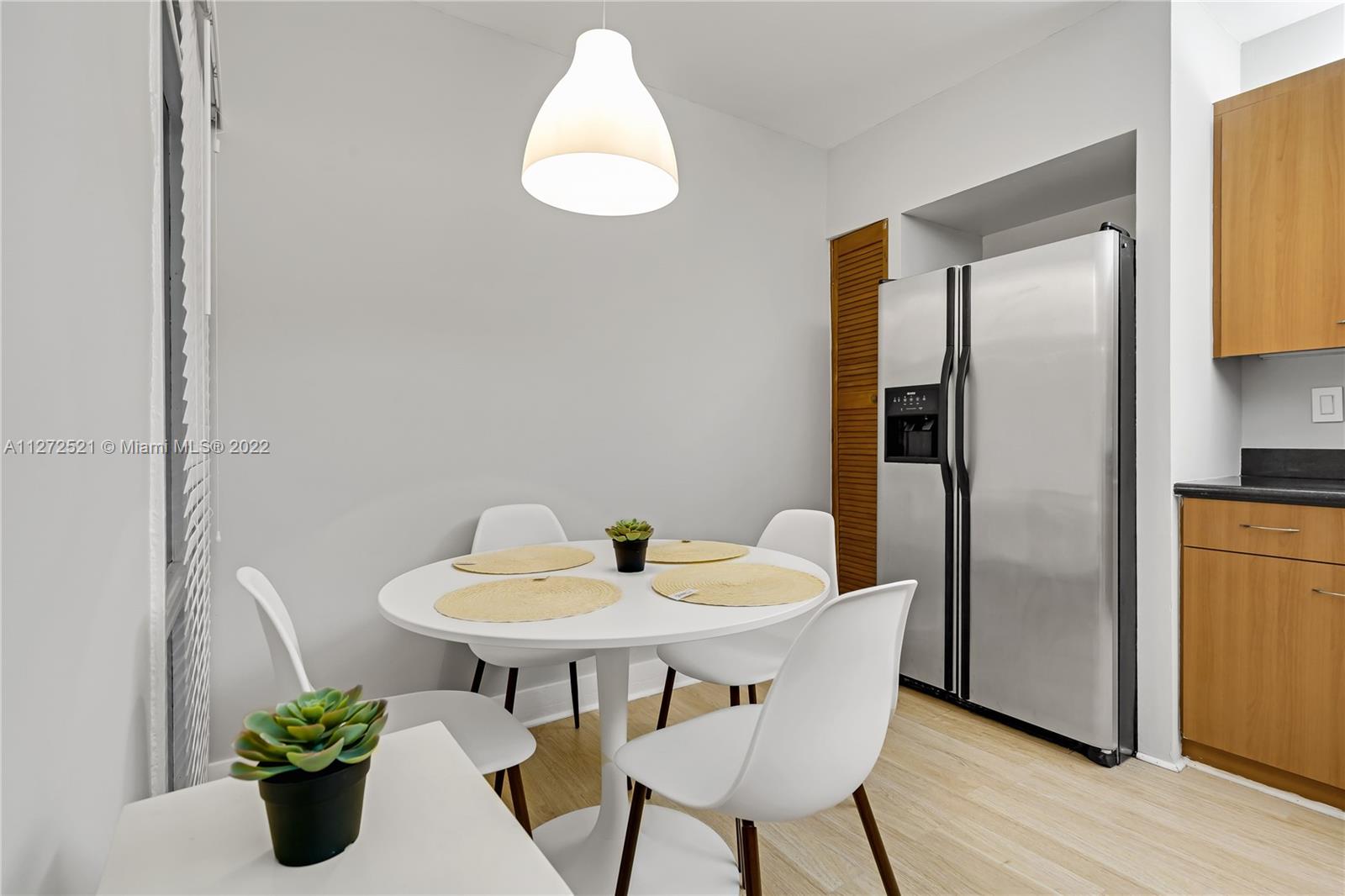 101 Crandon Boulevard, Unit 267 Key Biscayne, FL 33149 - Photo 13 of 57 a dining room with furniture and wooden floor