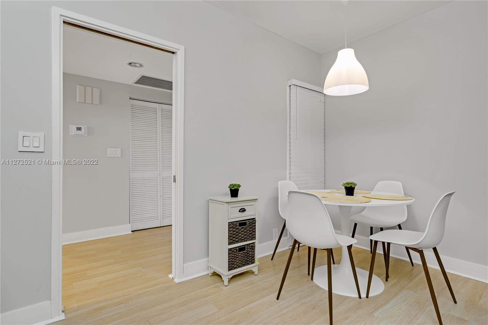 101 Crandon Boulevard, Unit 267 Key Biscayne, FL 33149 - Photo 14 of 57 a view of a dining room with furniture and wooden floor