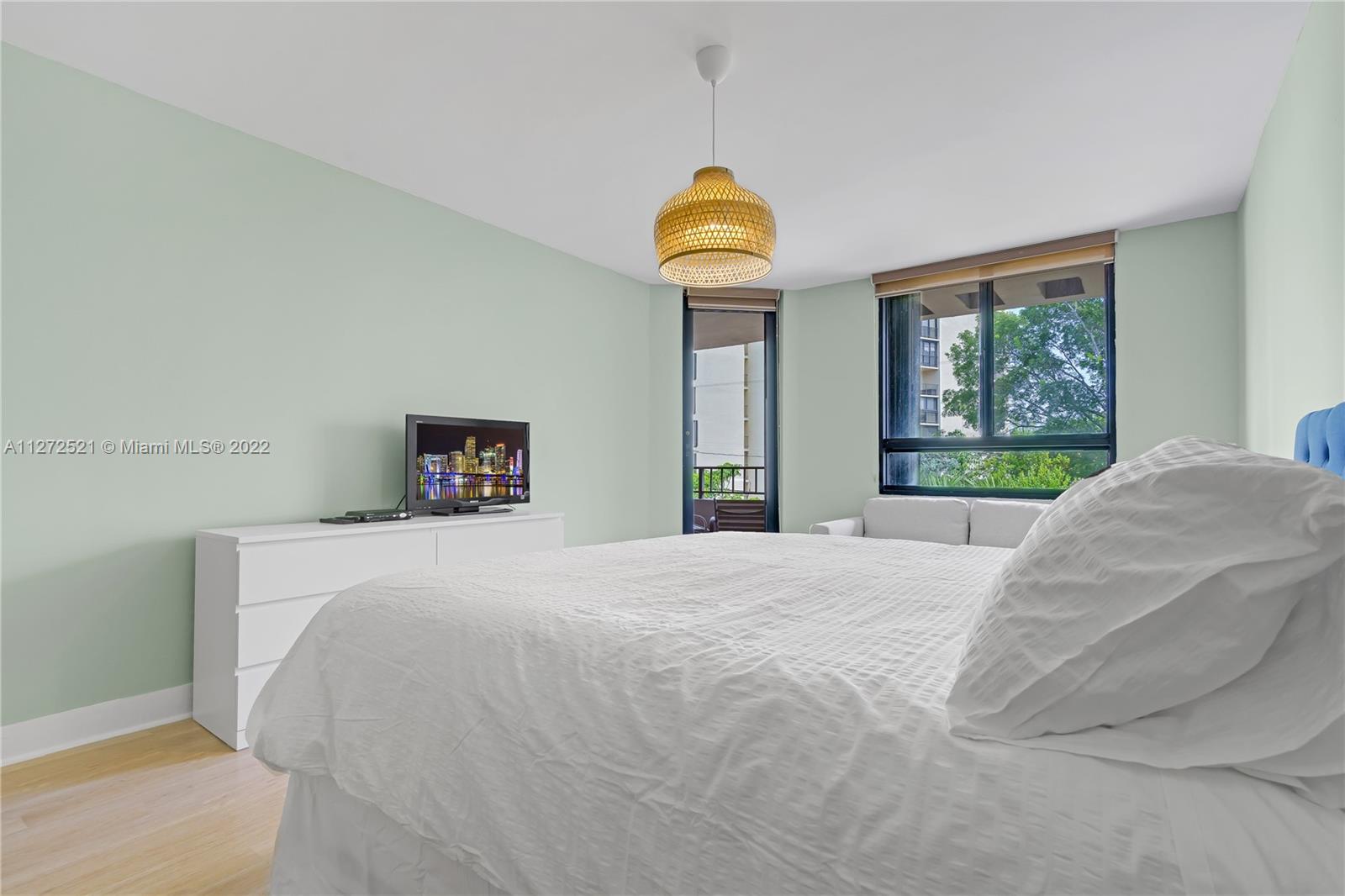 101 Crandon Boulevard, Unit 267 Key Biscayne, FL 33149 - Photo 17 of 57 a bedroom with a bed and a window