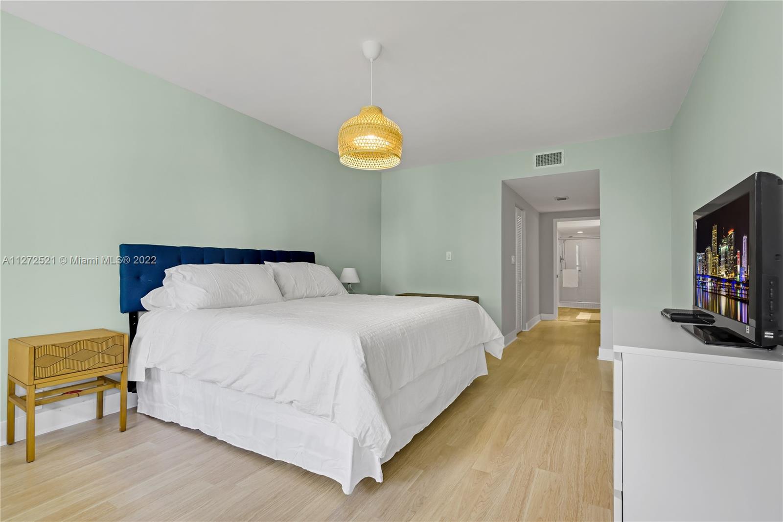 101 Crandon Boulevard, Unit 267 Key Biscayne, FL 33149 - Photo 18 of 57 a bedroom with a bed and wooden floor