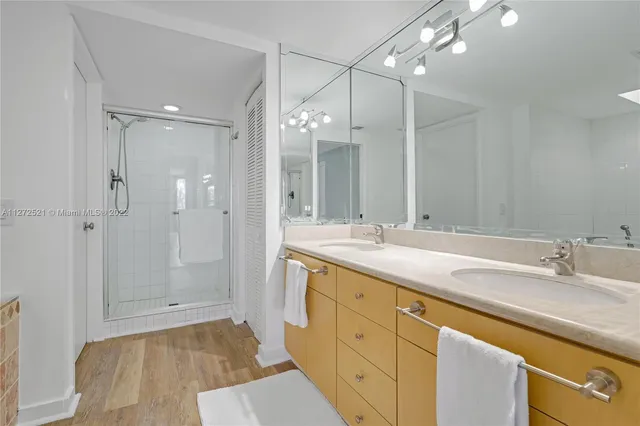 a spacious bathroom with a double vanity sink and a mirror