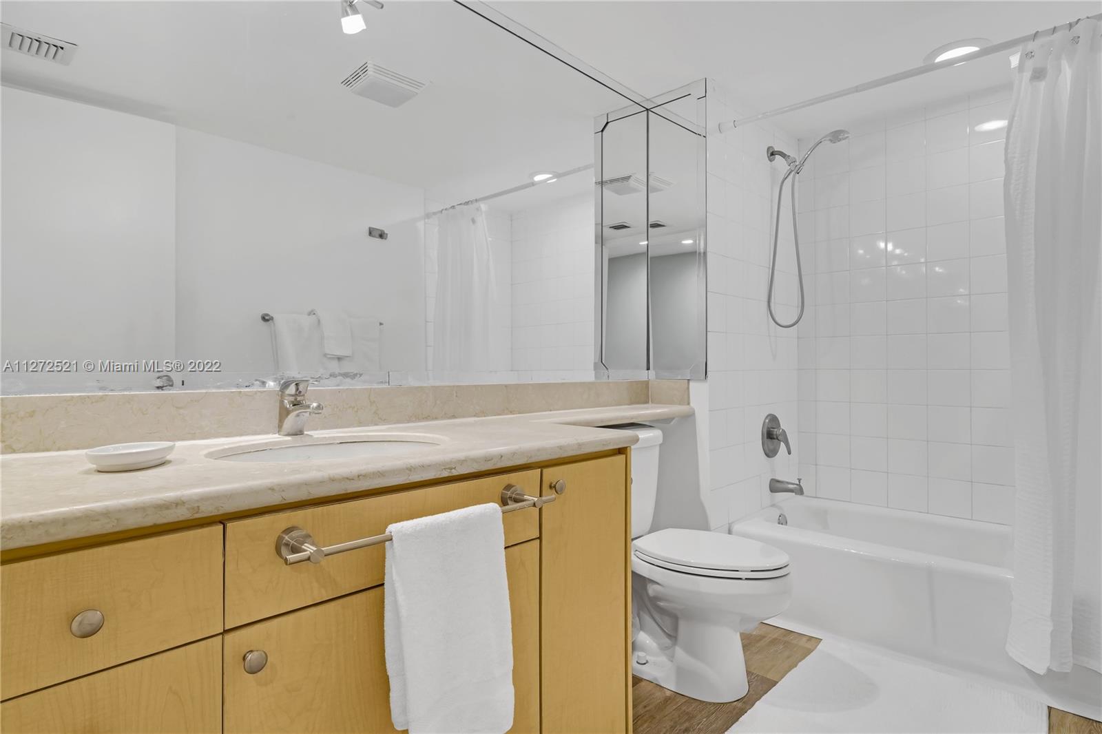 101 Crandon Boulevard, Unit 267 Key Biscayne, FL 33149 - Photo 30 of 57 a bathroom with a granite countertop sink toilet and shower