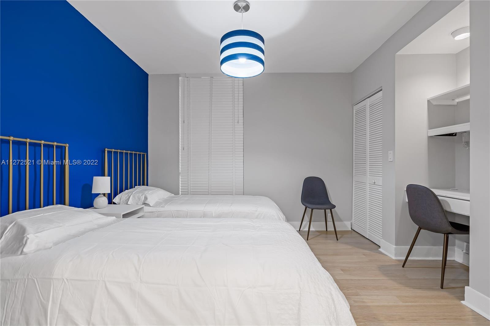 101 Crandon Boulevard, Unit 267 Key Biscayne, FL 33149 - Photo 33 of 57 a bedroom with a bed and a chair