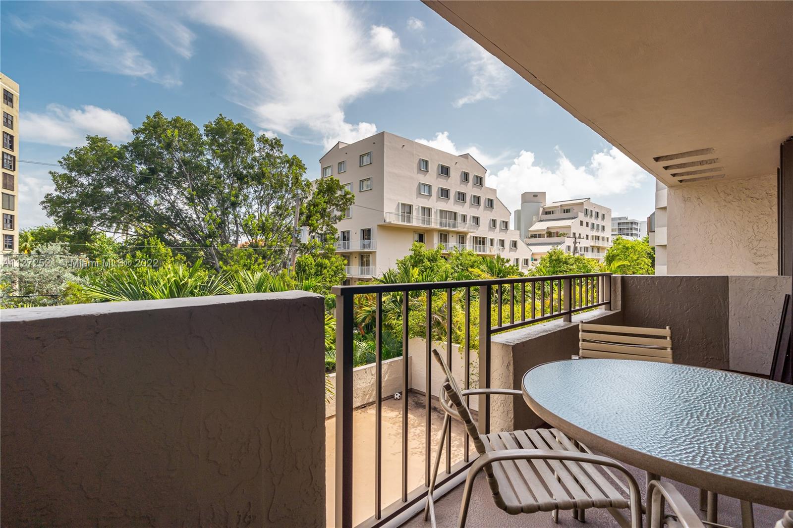 101 Crandon Boulevard, Unit 267 Key Biscayne, FL 33149 - Photo 36 of 57 a view of a balcony with wooden floor and outdoor seating