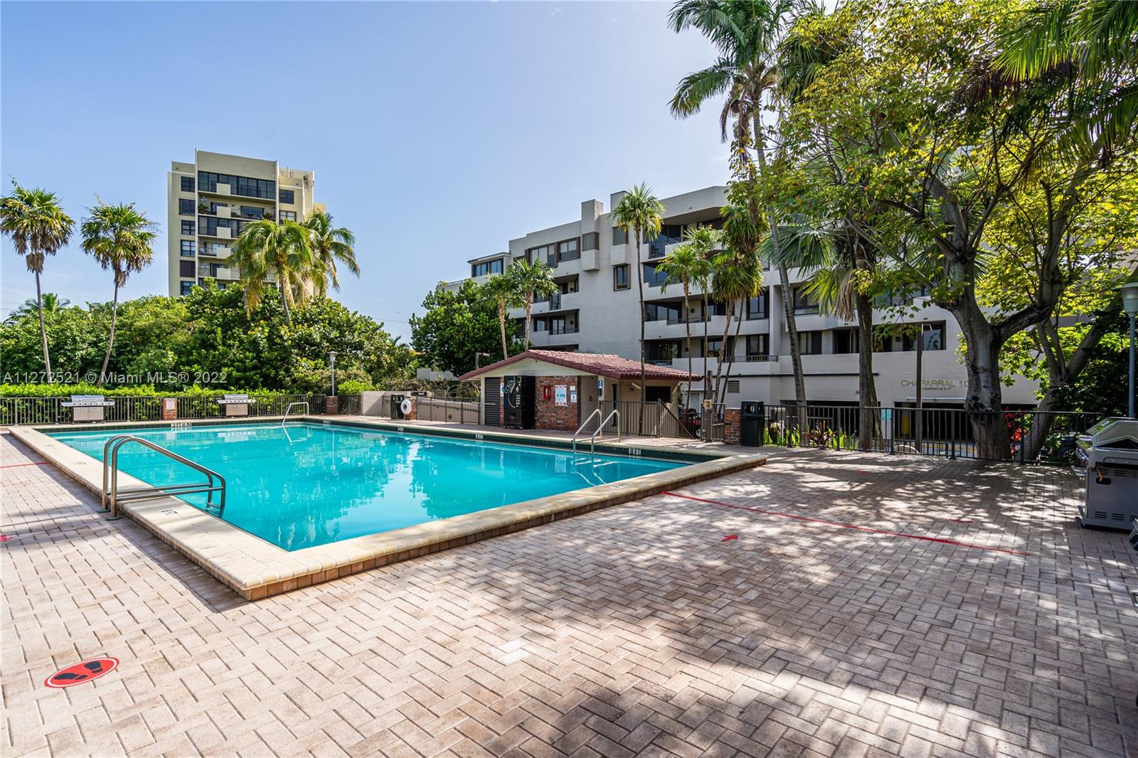 101 Crandon Boulevard, Unit 267 Key Biscayne, FL 33149 - Photo 40 of 57 a view of a swimming pool with a patio and a yard