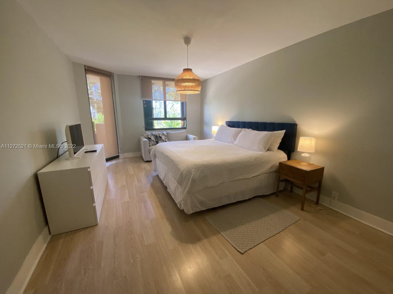 101 Crandon Boulevard, Unit 267 Key Biscayne, FL 33149 - Photo 55 of 57 a bedroom with a bed and window