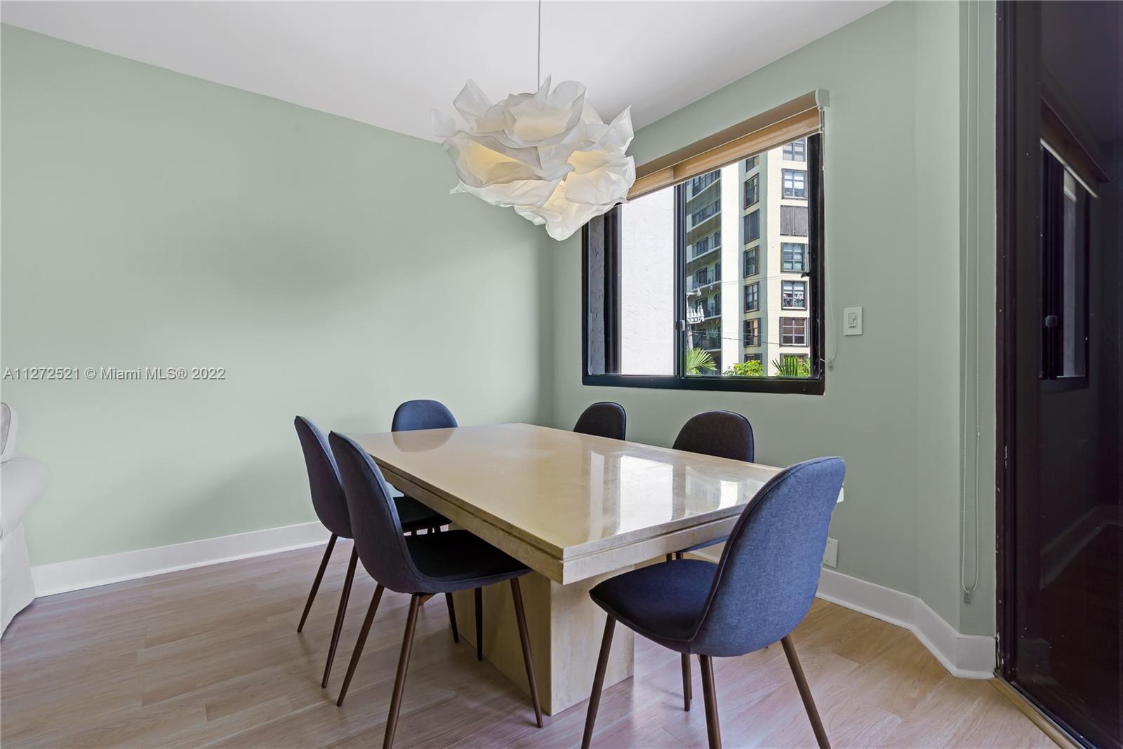 101 Crandon Boulevard, Unit 267 Key Biscayne, FL 33149 - Photo 8 of 57 a view of a dining room with furniture window and wooden floor