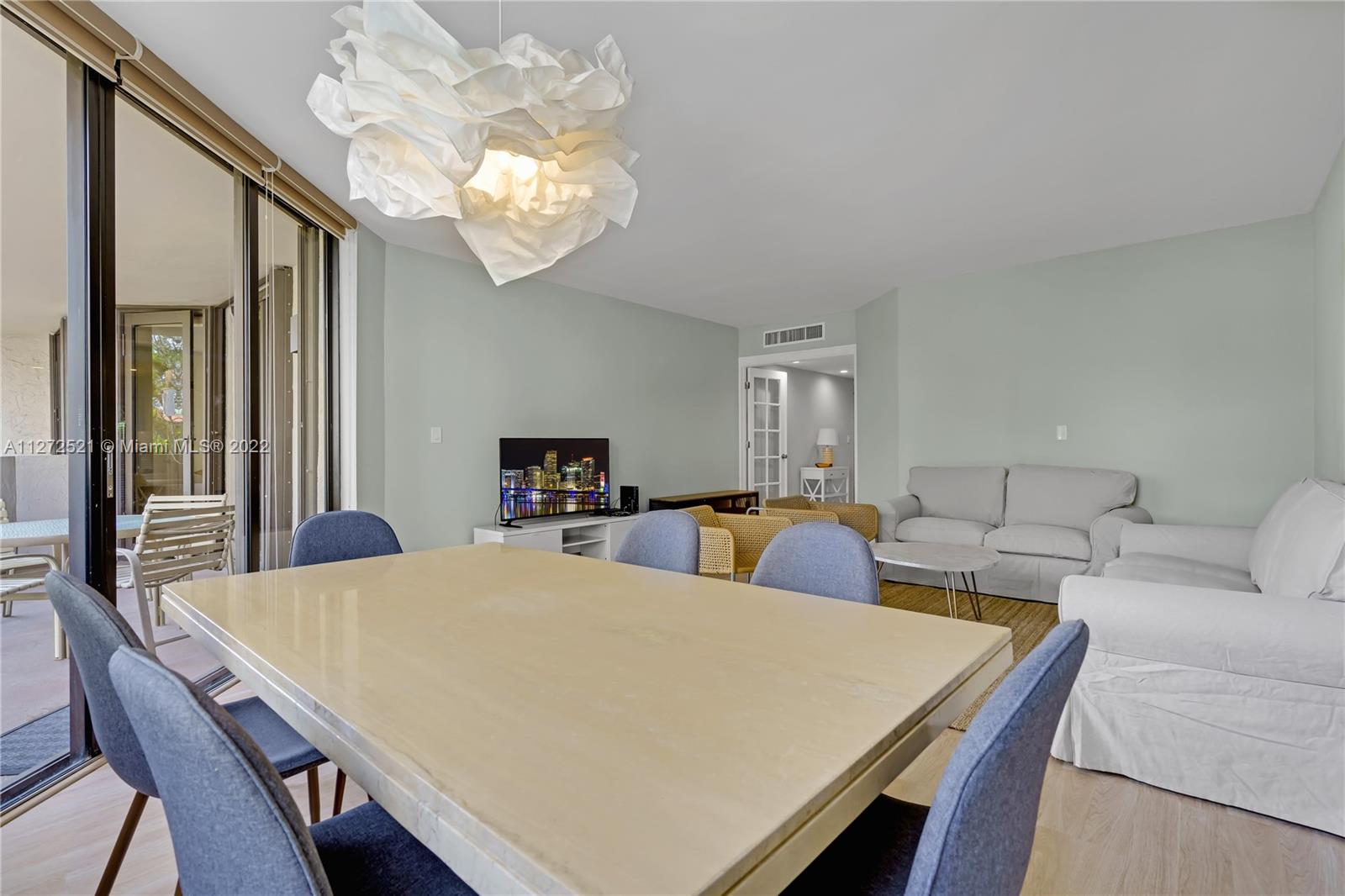 101 Crandon Boulevard, Unit 267 Key Biscayne, FL 33149 - Photo 9 of 57 a view of a dining room with furniture and a chandelier