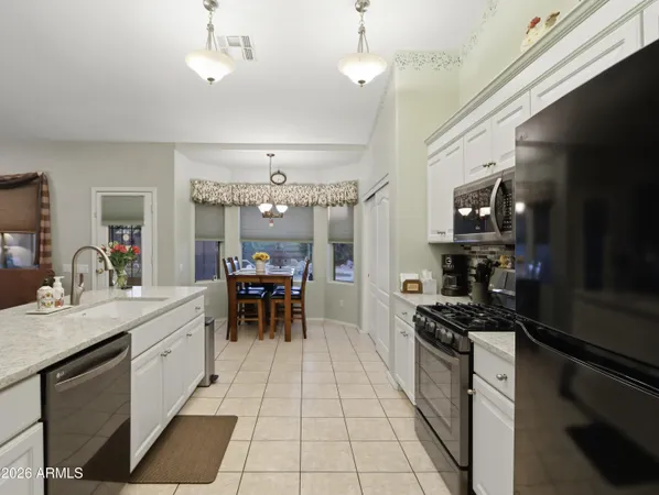 a kitchen with a sink stainless steel appliances and cabinets