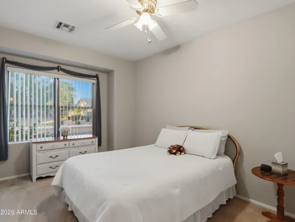 a livingroom with workspace couch and a window