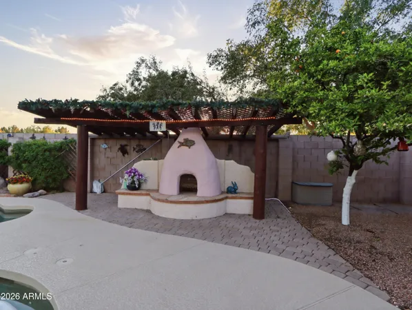 a front view of a house with patio and garden