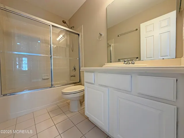 a bathroom with a toilet a sink and shower