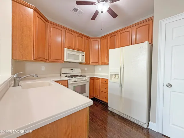 a white refrigerator freezer sitting inside of a kitchen