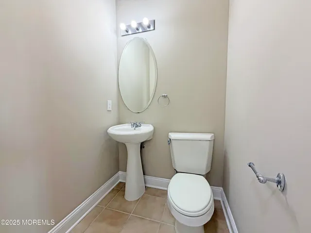 a bathroom with a toilet sink and a mirror
