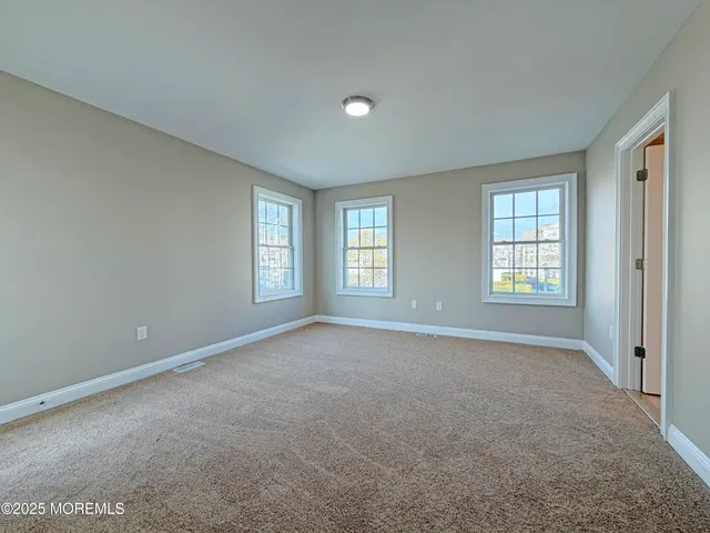 a view of an empty room with windows