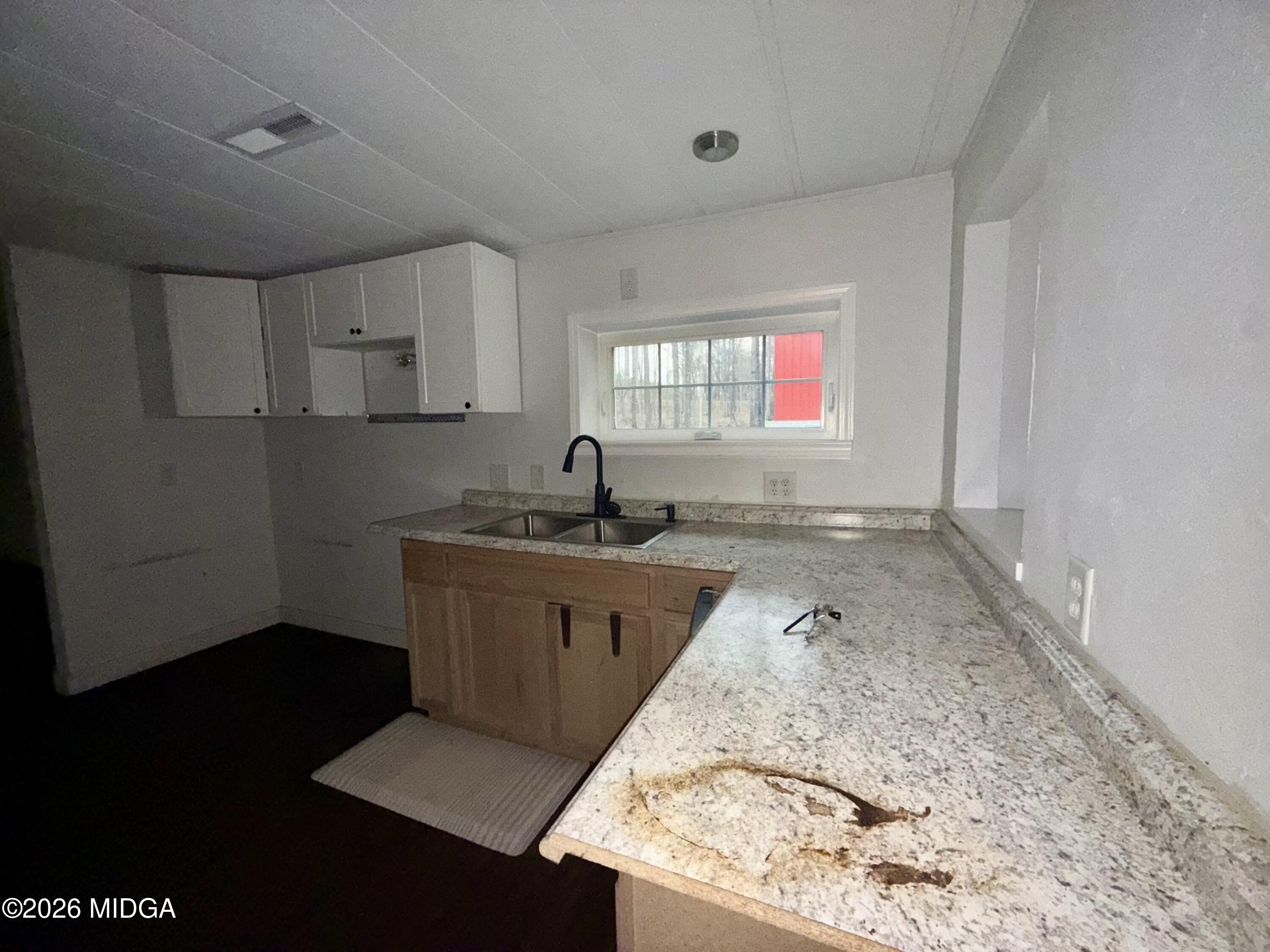 307 Old Dames Ferry Road Juliette, GA 31046 - Photo 2 of 13 a kitchen with granite countertop sink stove and cabinets