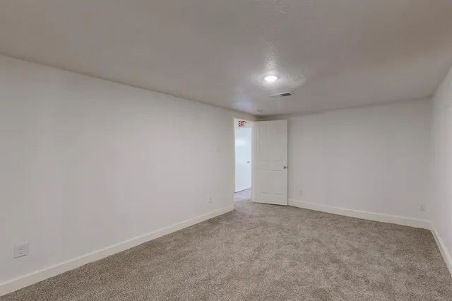 a view of an empty room and a window