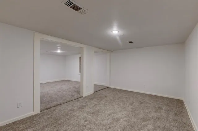 a bathroom with a granite countertop sink and a toilet