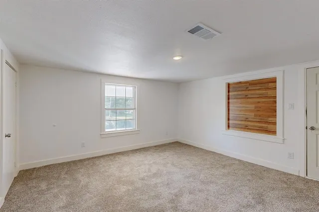 a bathroom with a granite countertop toilet sink and mirror