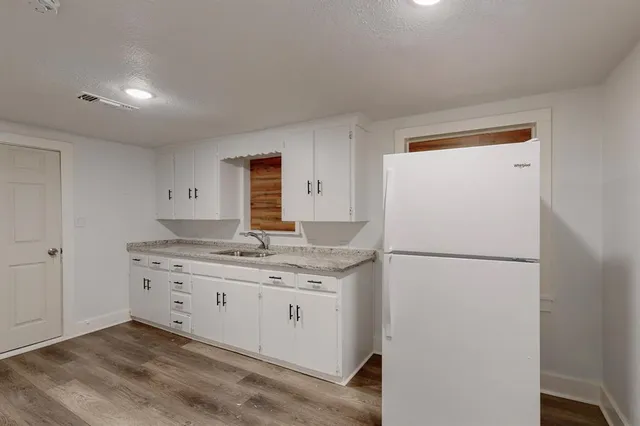 a kitchen with a granite countertop cabinets and white appliances
