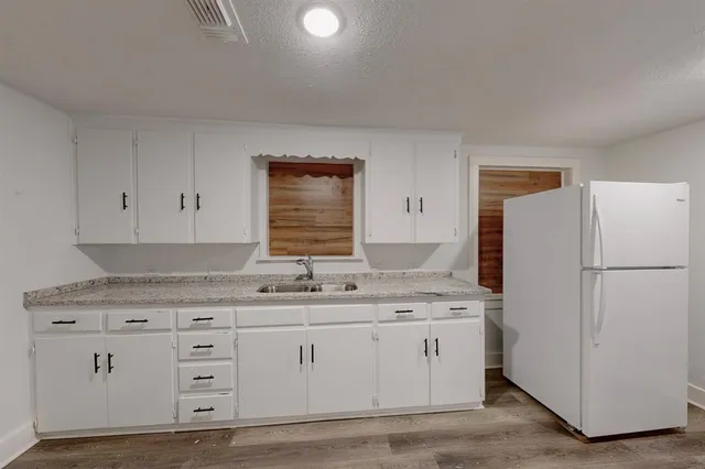 a kitchen with a sink and refrigerator