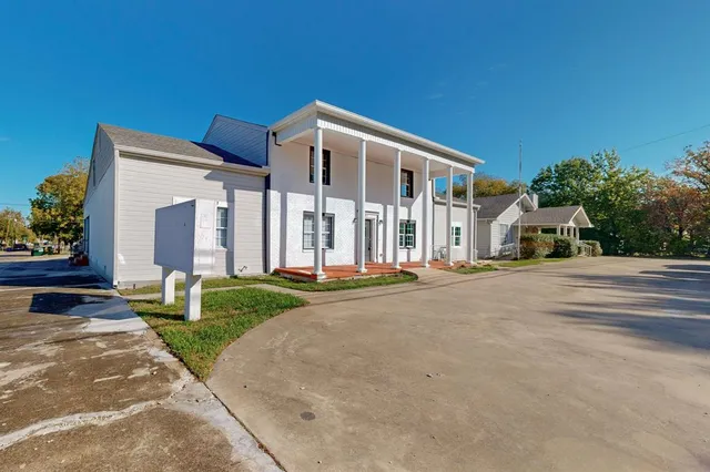 a bathroom with a granite countertop sink toilet and mirror