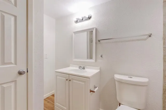 a white toilet sitting next to a white tub