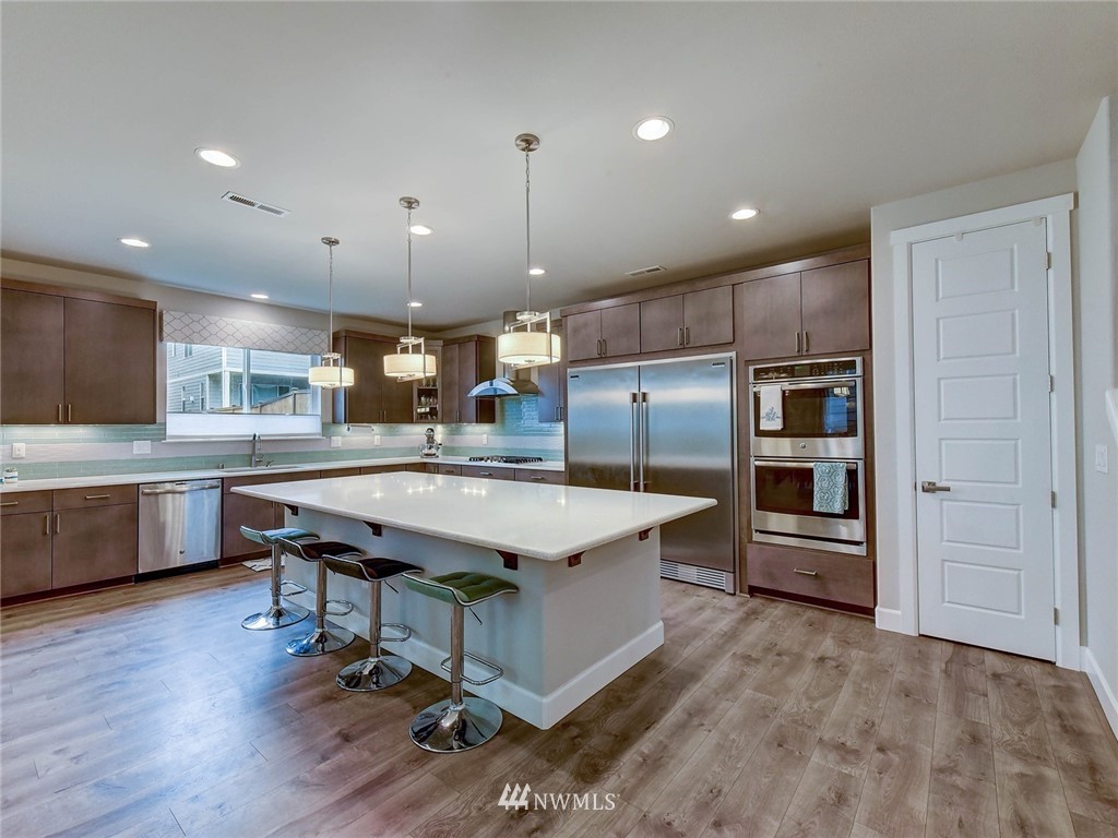 318 181st Street Southeast Bothell, WA 98012 - Photo 8 of 24 a large kitchen with a table and chairs in it