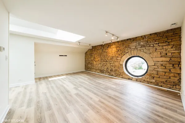 a view of a room with wooden floor and window