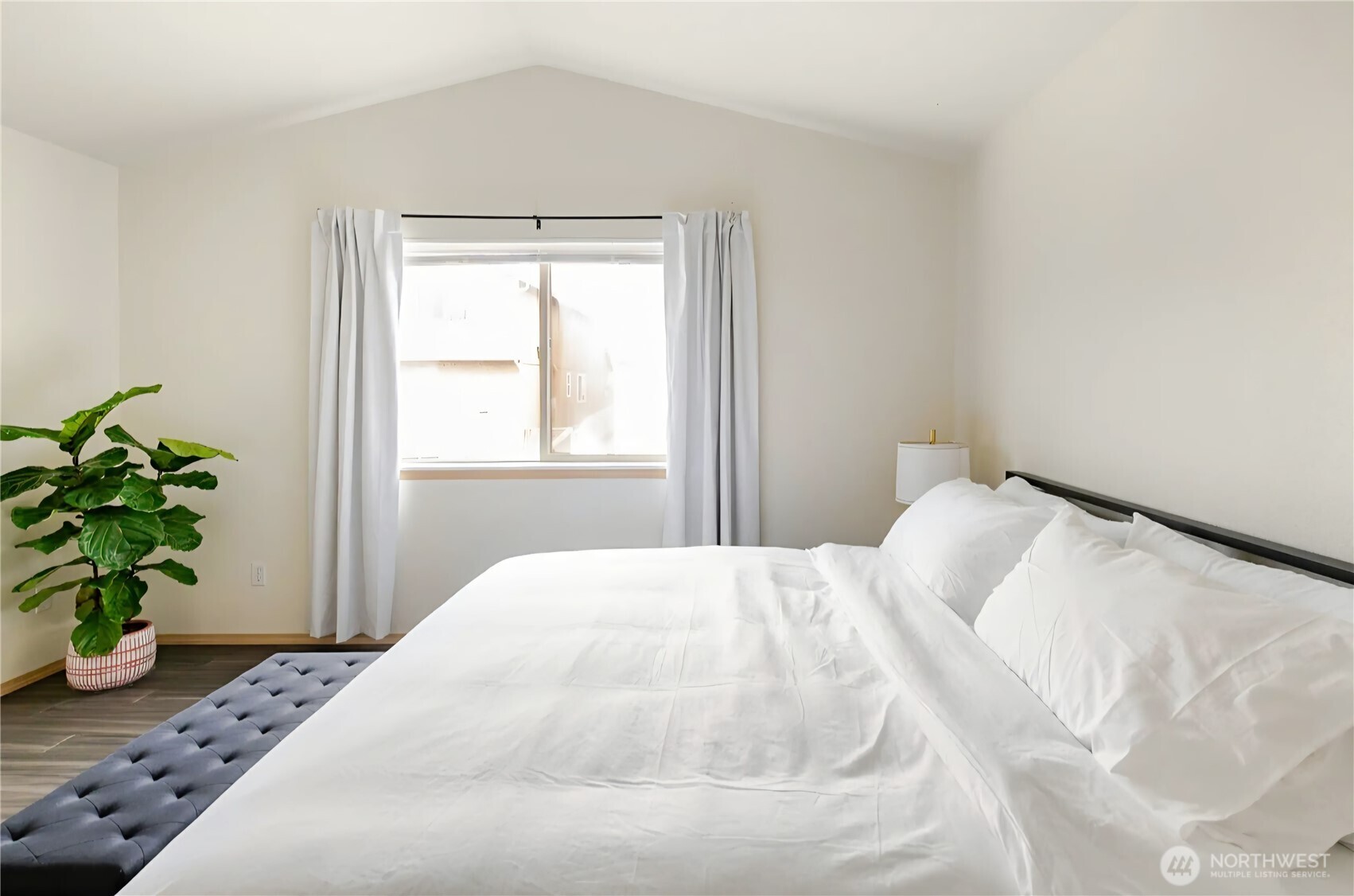 10047 17th Avenue Southwest Seattle, WA 98146 - Photo 12 of 27 a bedroom with a bed and a window