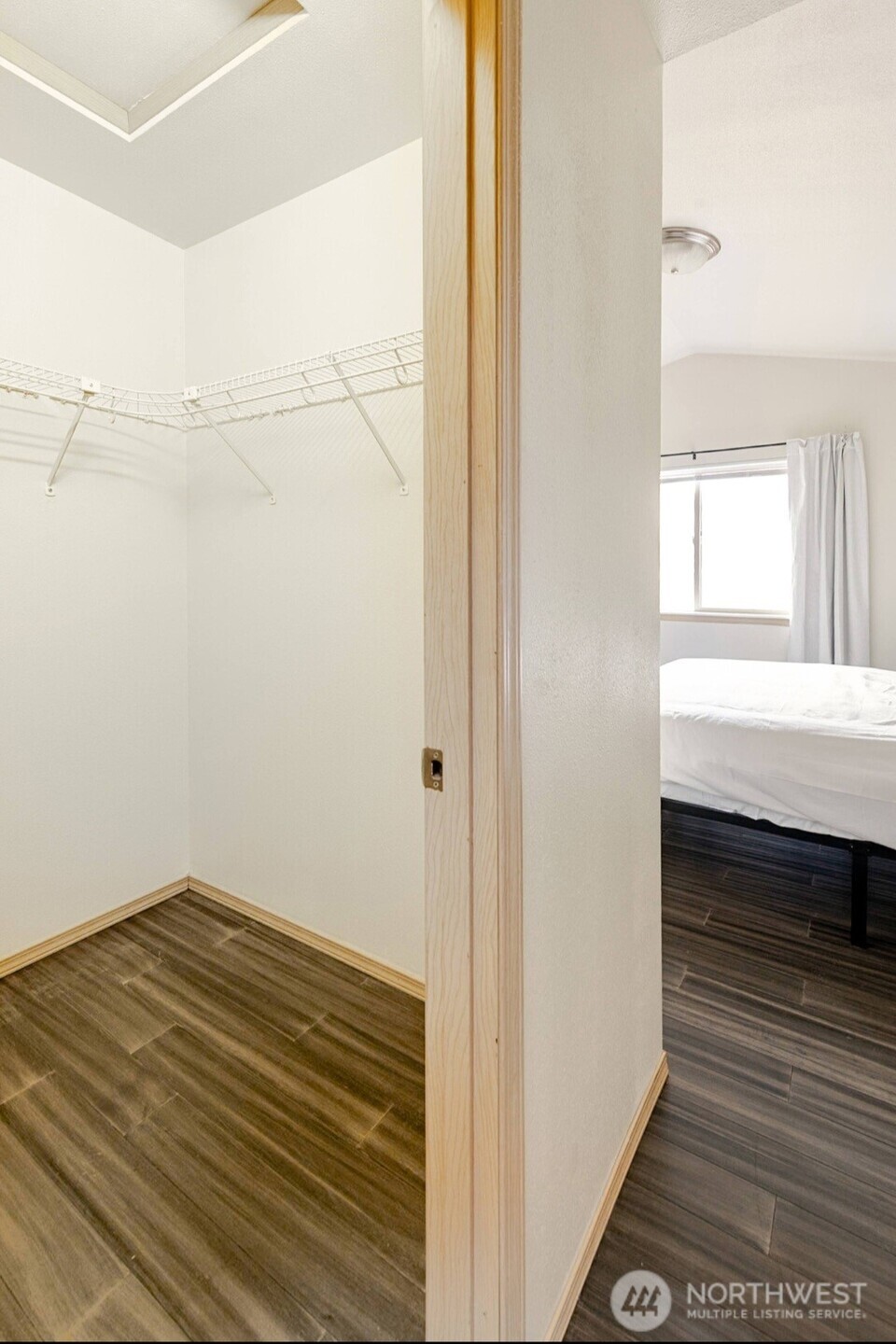10047 17th Avenue Southwest Seattle, WA 98146 - Photo 13 of 27 a view of a room with wooden floor and white walls