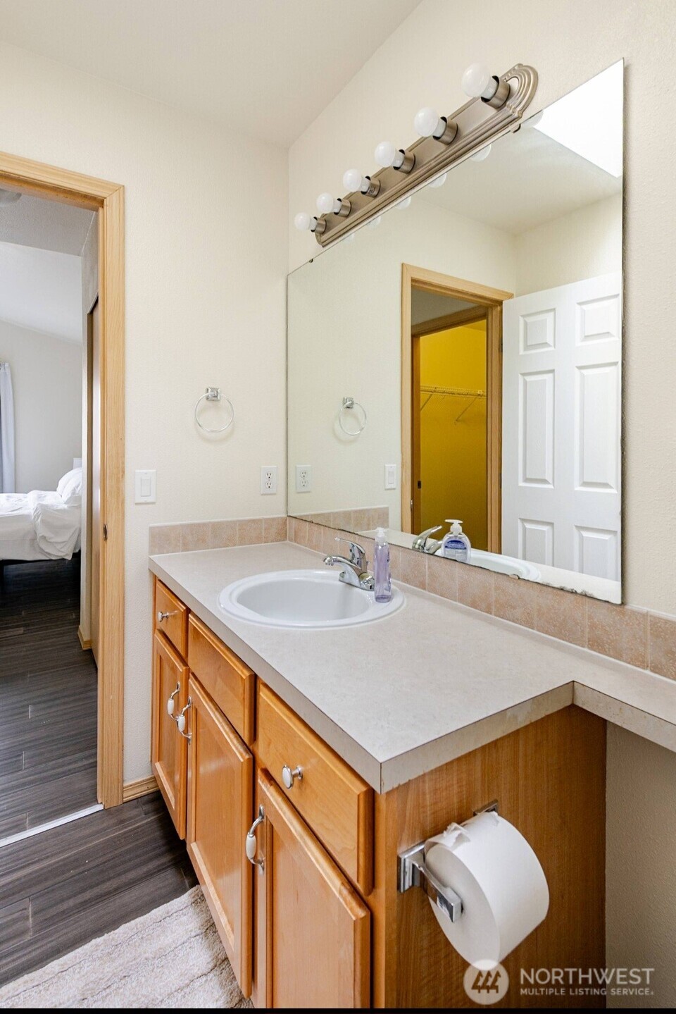 10047 17th Avenue Southwest Seattle, WA 98146 - Photo 16 of 27 a bathroom with a sink and a mirror